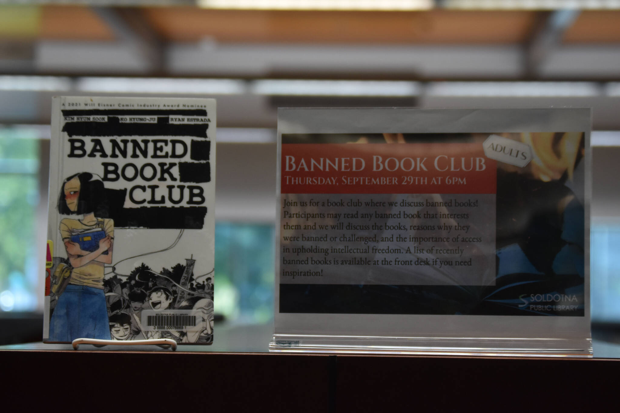 A sign promoting Banned Book Club is seen on Saturday, Sept. 24, 2022, at the Soldotna Public Library in Soldotna, Alaska. (Jake Dye/Peninsula Clarion)
