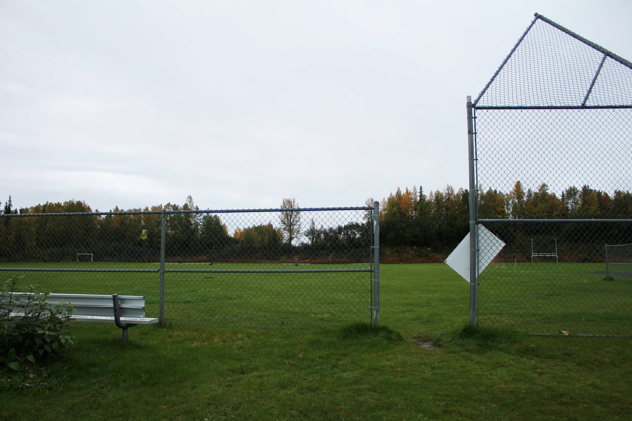 Fencing surrounds the upper fields at Nikiski Middle/High School on Monday, Sept. 19, 2022. The field is the proposed relocation site of the school’s track and field, which is part of a bond package Kenai Peninsula Borough voters will consider next month. (Ashlyn O’Hara/Peninsula Clarion)