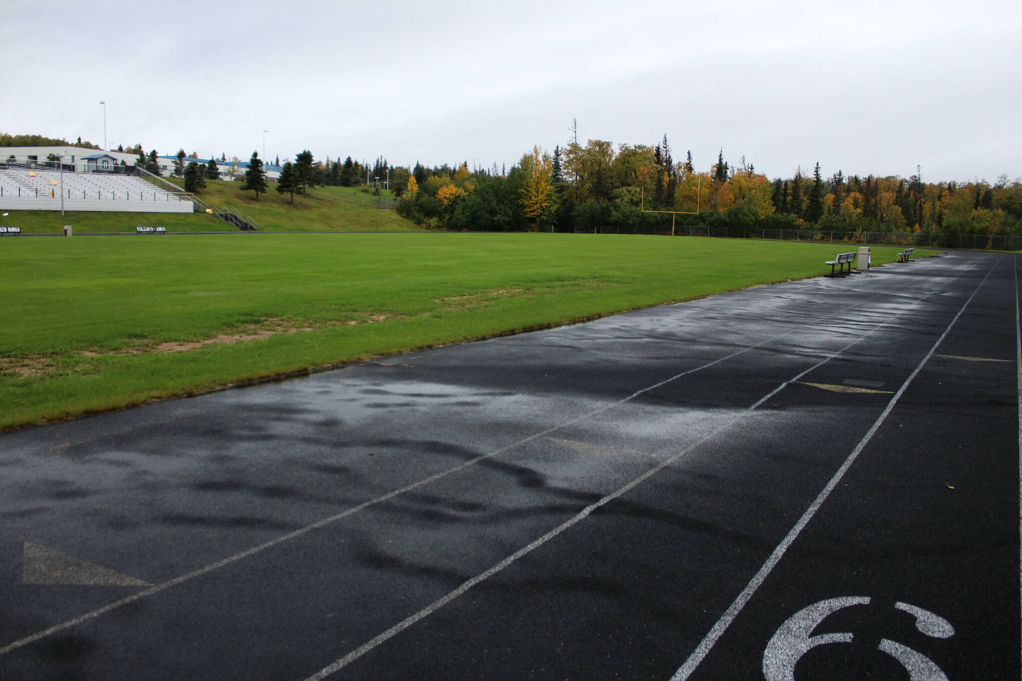 Water pools on a warped track at Nikiski Middle/High School on Monday, Sept. 19, 2022, in Nikiski, Alaska. The track is one of several projects in a bond package Kenai Peninsula voters will consider during the Oct. 4 municipal election next month. (Ashlyn O’Hara/Peninsula Clarion)