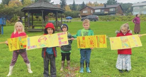 Paul Banks First Grade students hold handmade We Love Homer signs at WKFL Park after a field trip visiting the Police Station, Post Office and WKFL Park, learning about citizenship, community and helpers within the City of Homer. When asked, “Why do you love Homer?”, two of the students responded: “Because it’s such a great place.” (Ella Christman); “Because there’s lots of animals and it’s pretty.” (Coraline Jones-Bear) Photo by Christina Whiting. From left to right: Linnea, Matfey, Bowie, Gus, Vera