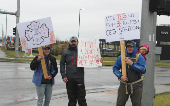 From left, Becca Satathite, Joshua Thompson, Spencer McLean and Emma McLean waive signs in support of Proposition 3 at the intersection of the Kenai Spur and Sterling Highways on Tuesday, Oct. 4, 2022, in Soldotna, Alaska. (Ashlyn O’Hara/Peninsula Clarion)