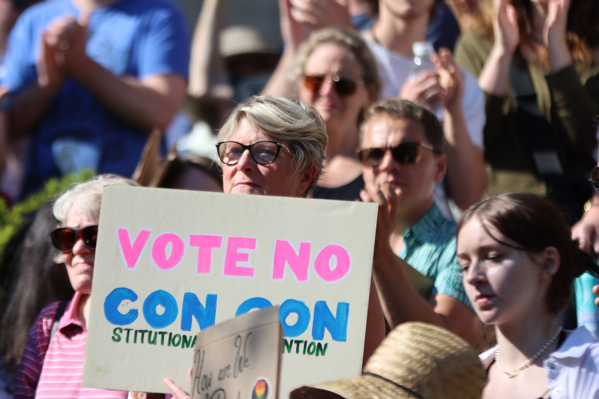 Former Democratic state Rep. Beth Kerttula holds up a sign reading “Vot No Con Con,” during a rally at the Dimond Courthouse Plaza in Juneau. (Ben Hohenstatt / Juneau Empire File)
