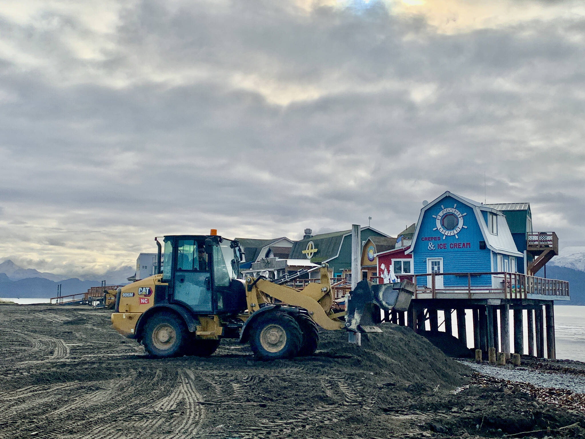 Collins Construction workers rebuild soil damaged during Sunday’s storm, paid by private businesses on the boardwalk, with material coming from the City dredge pile free of charge, Oct. 11, 2022. (Photo by Christina Whiting/Homer News)