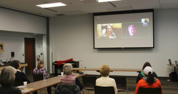 Candidates for Alaska State House District 6 Ginger Bryant, on screen, left, and Louie Flora, on screen, right, participate remotely in a forum held at the Soldotna Public Library on Monday, Oct. 24, 2022 in Soldotna, Alaska. (Ashlyn O’Hara/Peninsula Clarion)