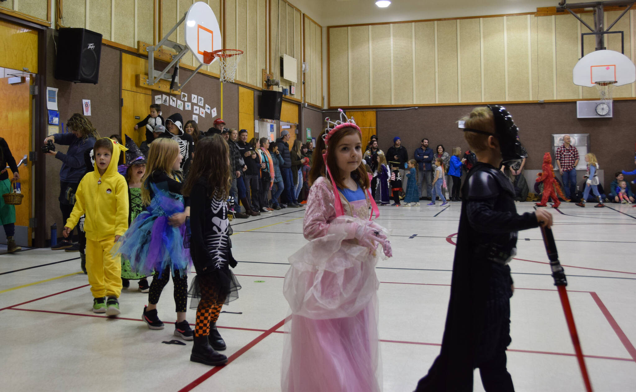 Pokemon, princesses, and an intergalactic leader enjoy their applause at the Paul Banks Elementary Halloween Parade on Monday, Oct. 31, 2022 in Homer, Alaska. (Photo by Charlie Menke / Homer News)