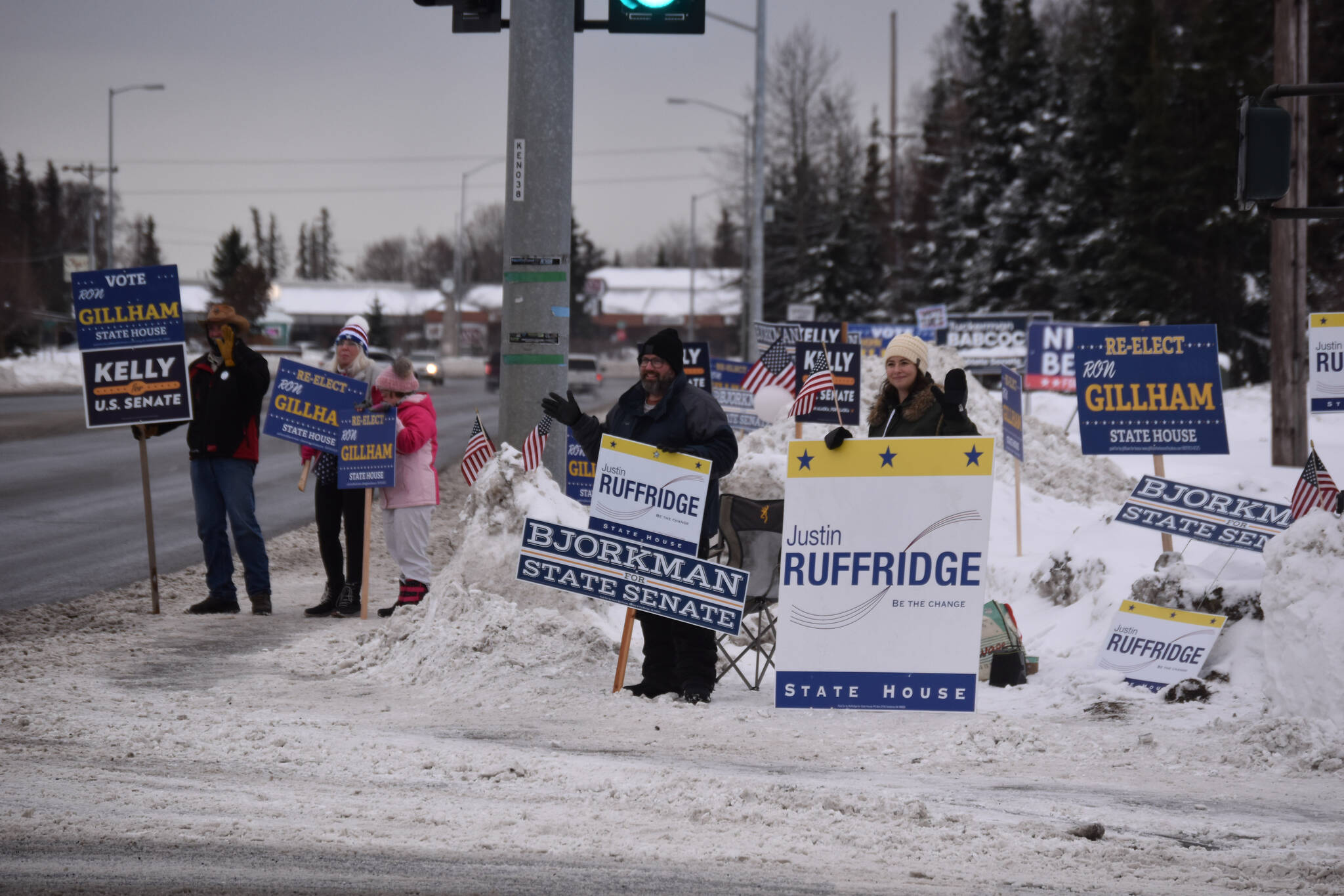 Candidate Ron Gillham, supporters of Gillham and other candidates and a slew of political signage are seen on Election Day, Nov. 8, 2022, at the intersection of the Kenai Spur Highway and Bridge Access Road in Kenai, Alaska. (Jake Dye/Peninsula Clarion)