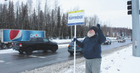 Ashlyn O’Hara/Peninsula Clarion
Larry Opperman waves a sign in support of Alaska House candidate Justin Ruffridge at the intersection of the Kenai Spur and Sterling highways on Tuesday in Soldotna.