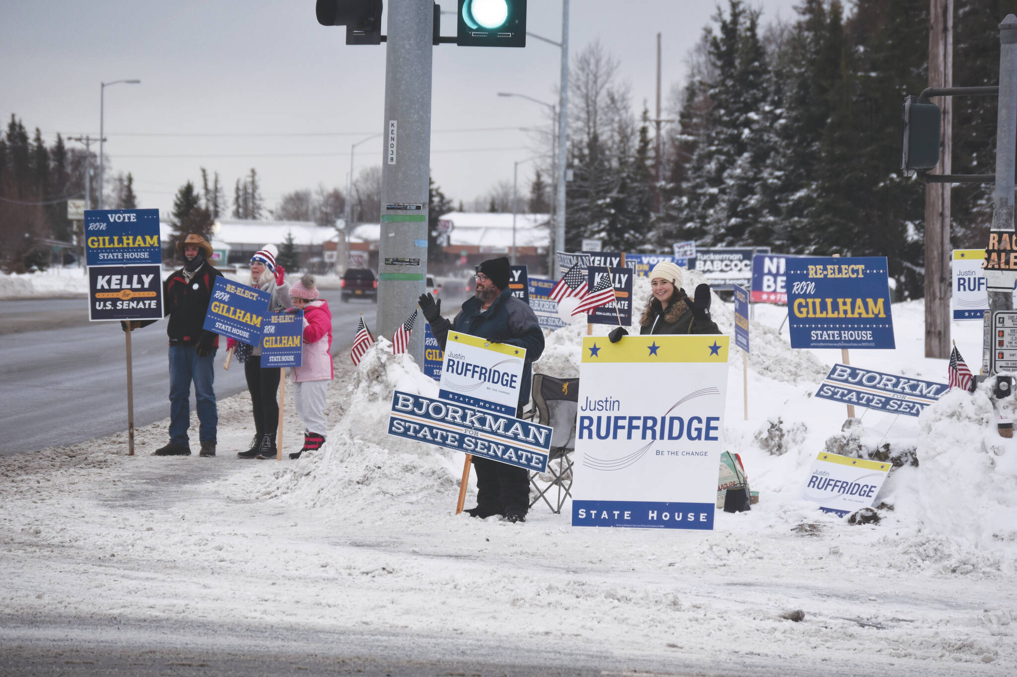 Jake Dye/Peninsula Clarion
Candidate Ron Gillham, supporters of Gillham and other candidates and a slew of political signage are seen on Election Day, at the intersection of the Kenai Spur Highway and Bridge Access Road in Kenai.