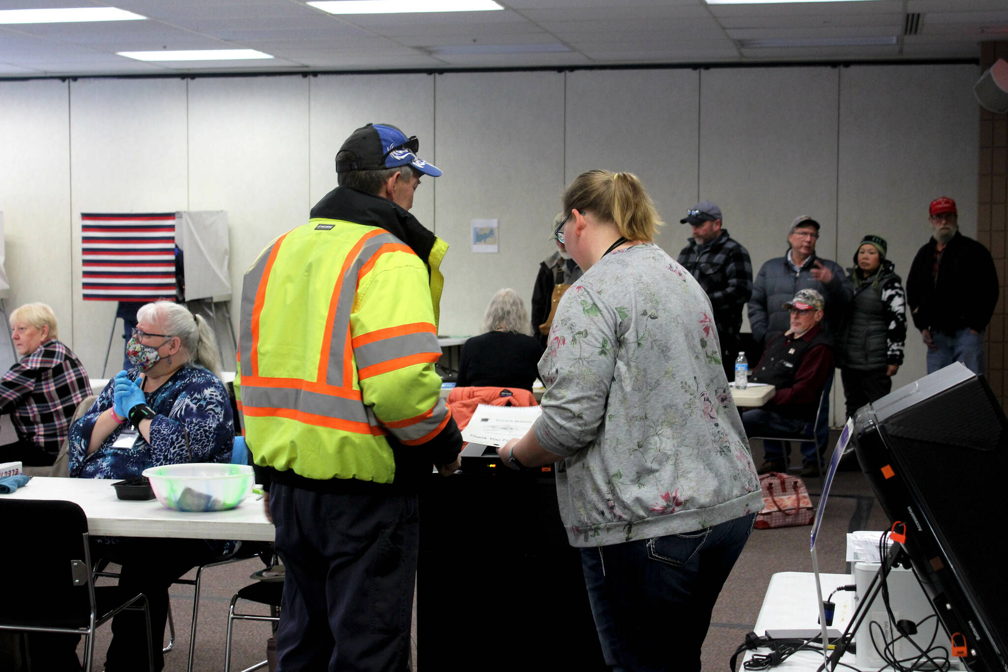 Poll worker Harmony Bolden (right) helps a voter cast their ballot at the Soldotna Regional Sports Complex on Tuesday, Nov. 8, 2022 in Soldotna, Alaska. (Ashlyn O'Hara/Peninsula Clarion)