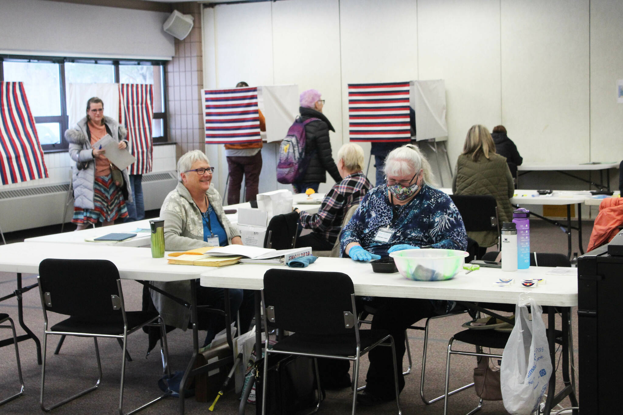 K-Beach Precinct Chair Kathy Carson (right) and Carol Louthan (left) assist voters at the Soldotna Regional Sports Complex on Tuesday, Nov. 8, 2022 in Soldotna, Alaska. (Ashlyn O'Hara/Peninsula Clarion)