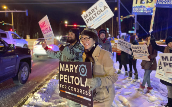 U.S. Rep. Mary Peltola waves a sign during the morning rush hour in Anchorage, Alaska, on Tuesday Nov. 8, 2022. Peltola, who became the first Alaska Native elected to Congress when she won a special election earlier this year, faces Republicans Sarah Palin and Nick Begich and Libertarian Chris Bye in the general election. (AP Photo/Mark Thiessen)