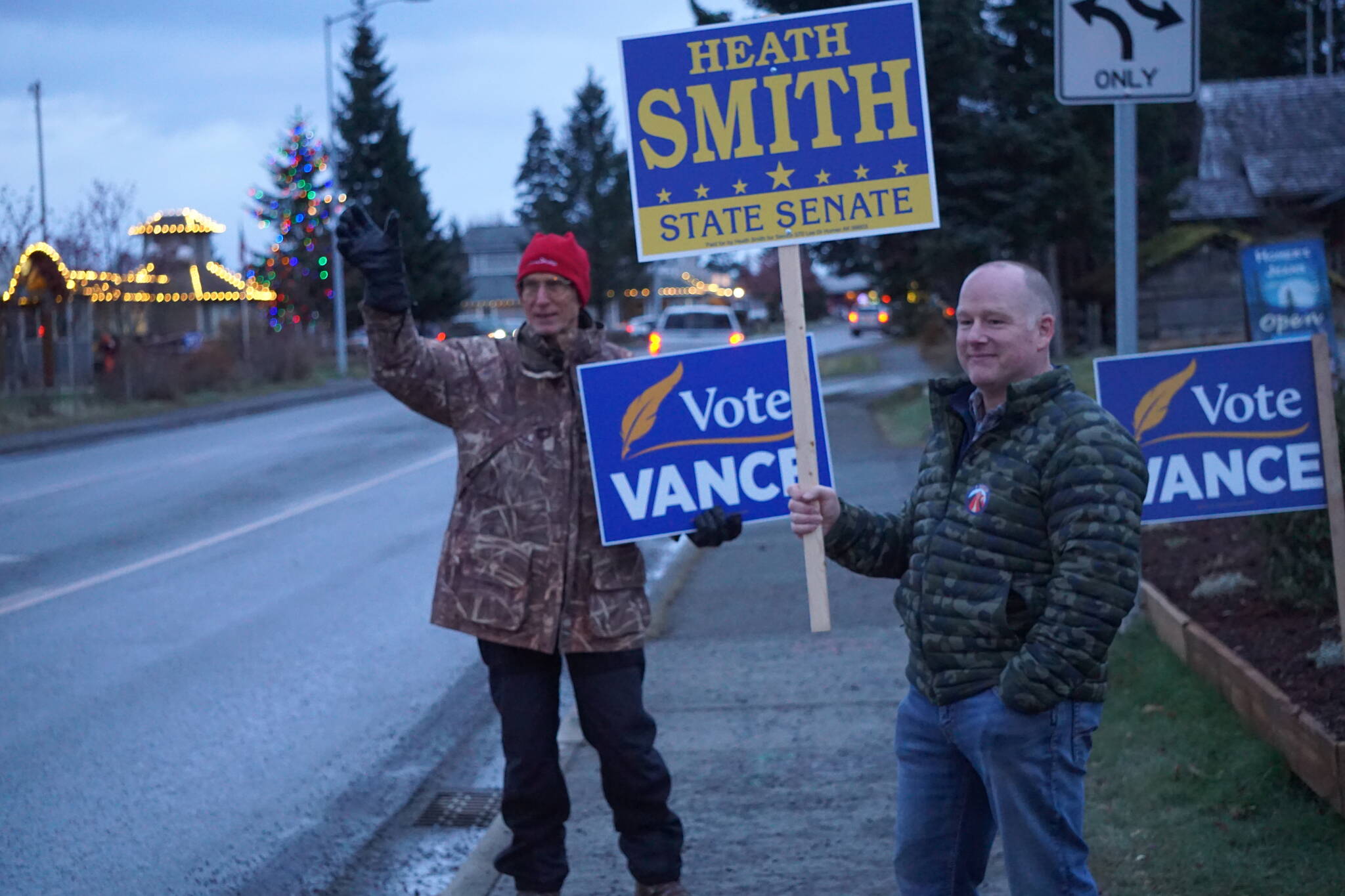 Heath Smith, right, Candidate for State Senate District C, waves signs on Tuesday, Nov. 8, 2022, on Pioneer Avenue in Homer, Alaska. At left, Charlie Franz shows his support for Rep. Sarah Vance, running for re-election and for the new District 6. (Photo by Michael Armstrong/Homer News)
