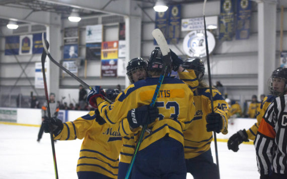 Mariners’ Casey Otis is rushed by his team after scoring against the Houston Hawks, with an assist by Hunter Green. The Mariners won 4-3 in overtime Friday night. (Photo by Sarah Knapp/Homer News)