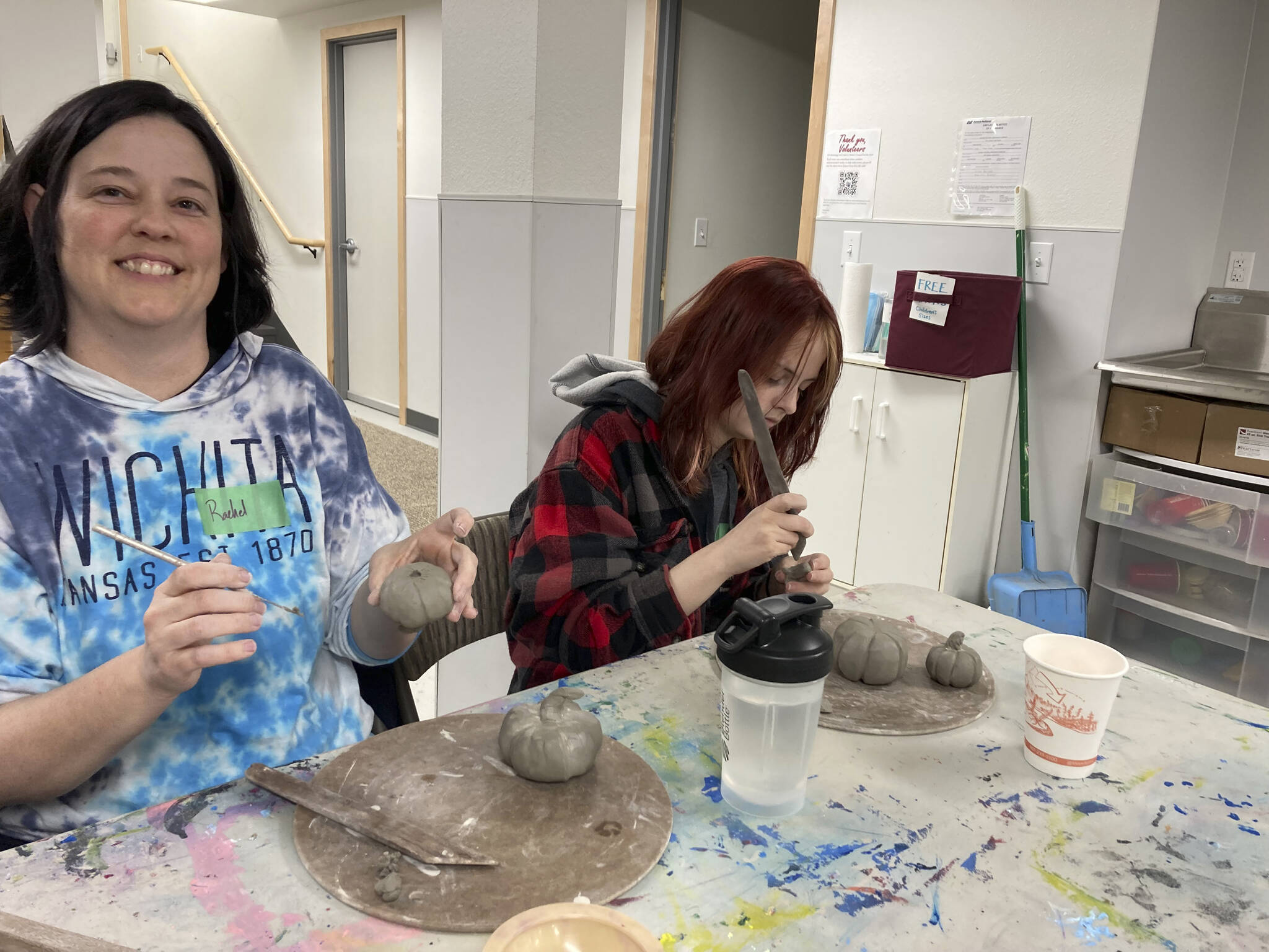 Mother and daughter Rachel and Audrey Bartel hand build pumpkins on Nov. 3, 2022, at the Homer Council on the Art's new ceramics studio in Homer, Alaska. (Photo provided)