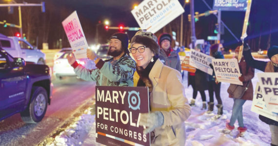 U.S. Rep. Mary Peltola waves a sign during the morning rush hour in Anchorage, Alaska, on Tuesday Nov. 8, 2022. Peltola, who became the first Alaska Native elected to Congress when she won a special election earlier this year, faces Republicans Sarah Palin and Nick Begich and Libertarian Chris Bye in the general election. (AP Photo/Mark Thiessen)