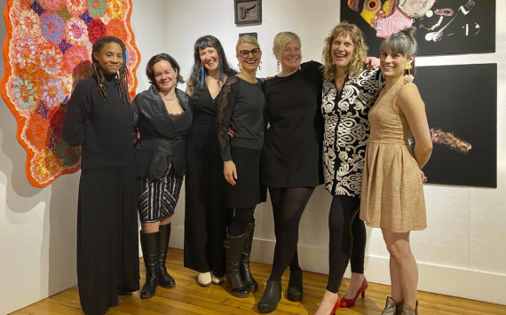 The artists who created the Mother exhibit pose for a group photo on Friday, Dec. 2, 2022, at Bunnell Street Arts Center in Homer. From left to right are Myesha Callahan Freet, Lily Wooshkindein Da.Aat Hope, Brianna Allen, Amy Meissner, Somer Hahm, Amy Komar and Carla Kilnker Cope. (Photo by Adele Person.)