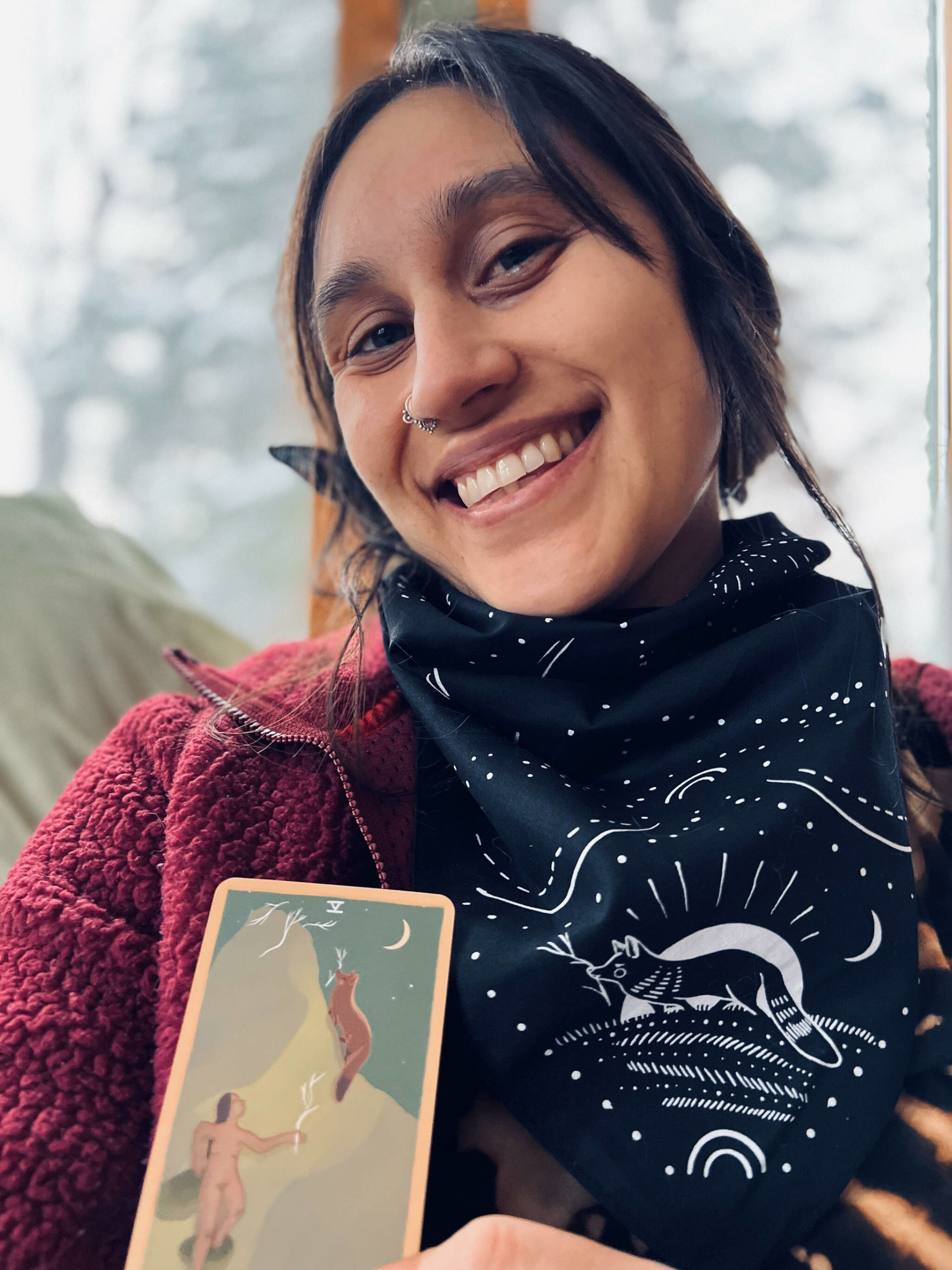 Mariza Ryce Aparicio-Tovar poses with a card from “The Gentle Tarot” deck. (Photo courtesy Ryce-Tovar)