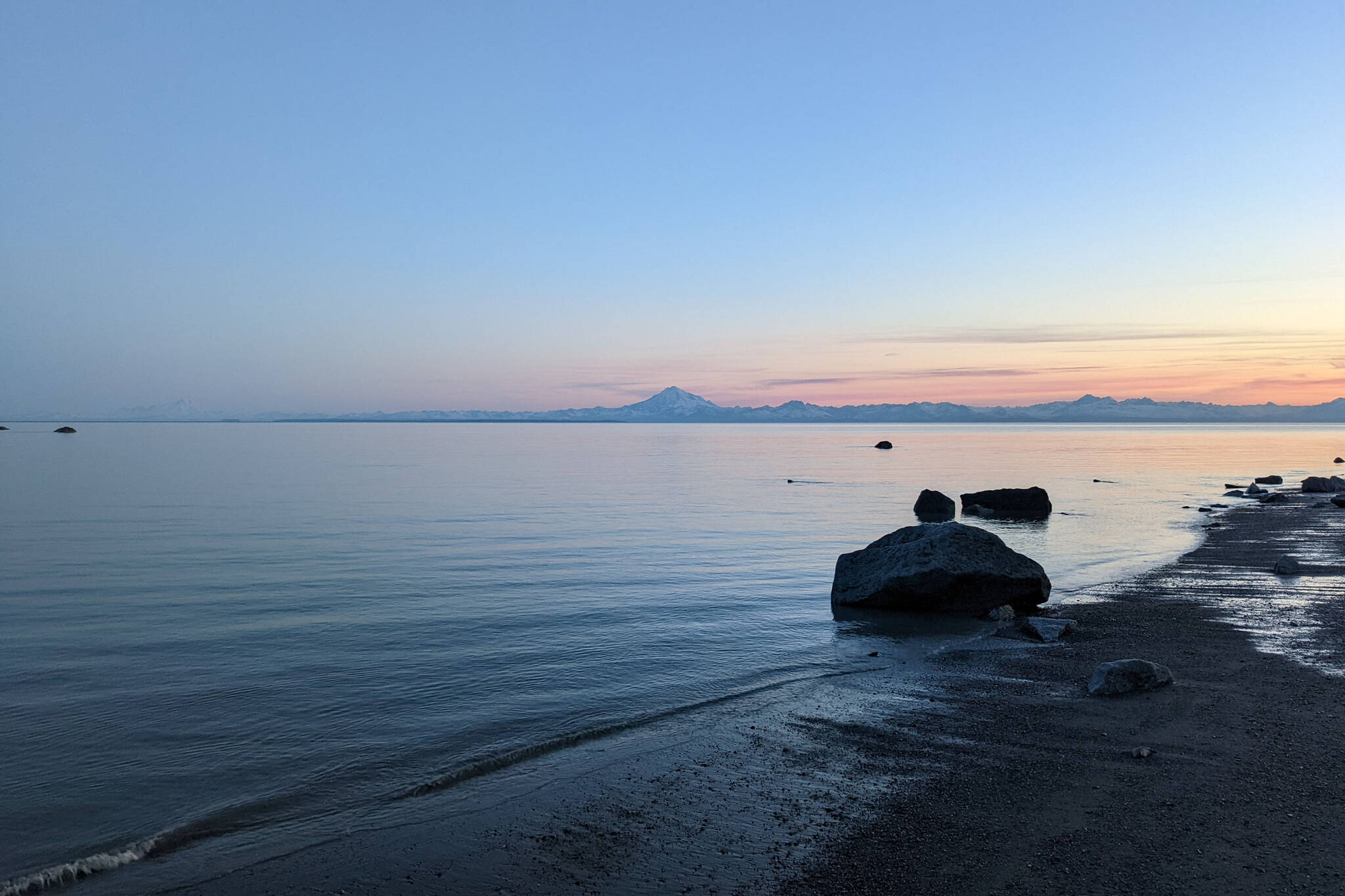 Mount Redoubt can be seen acoss Cook Inlet from North Kenai Beach on Thursday, July 2, 2022. (Peninsula Clarion file)
