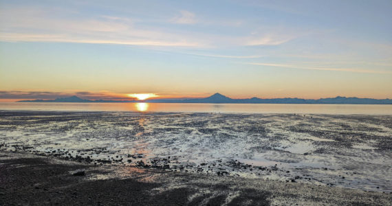 Mounts Iliamna and Redoubt are seen at sunset on Feb. 22, 2022, in Kenai, Alaska. (Photo by Erin Thompson/Peninsula Clarion)