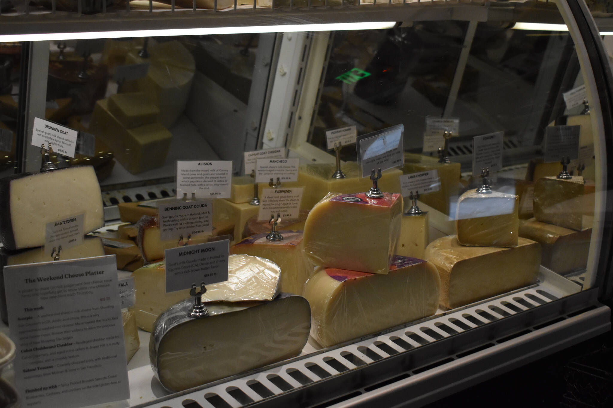 Artisanal cheeses are on display on Friday, Jan. 6, 2023 at Lucy’s Market in Soldotna, Alaska. (Jake Dye/Peninsula Clarion)