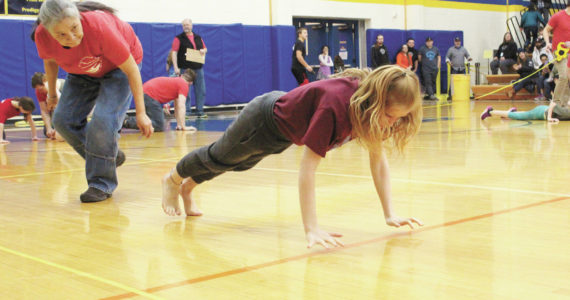 Grace Fleming of Seward competes in the seal hop Saturday, March 7, 2020 during the Kachemak Bay Traditional Games, a Native Youth Olympics invitational, at Homer High School in Homer, Alaska. (Photo by Megan Pacer/Homer News)