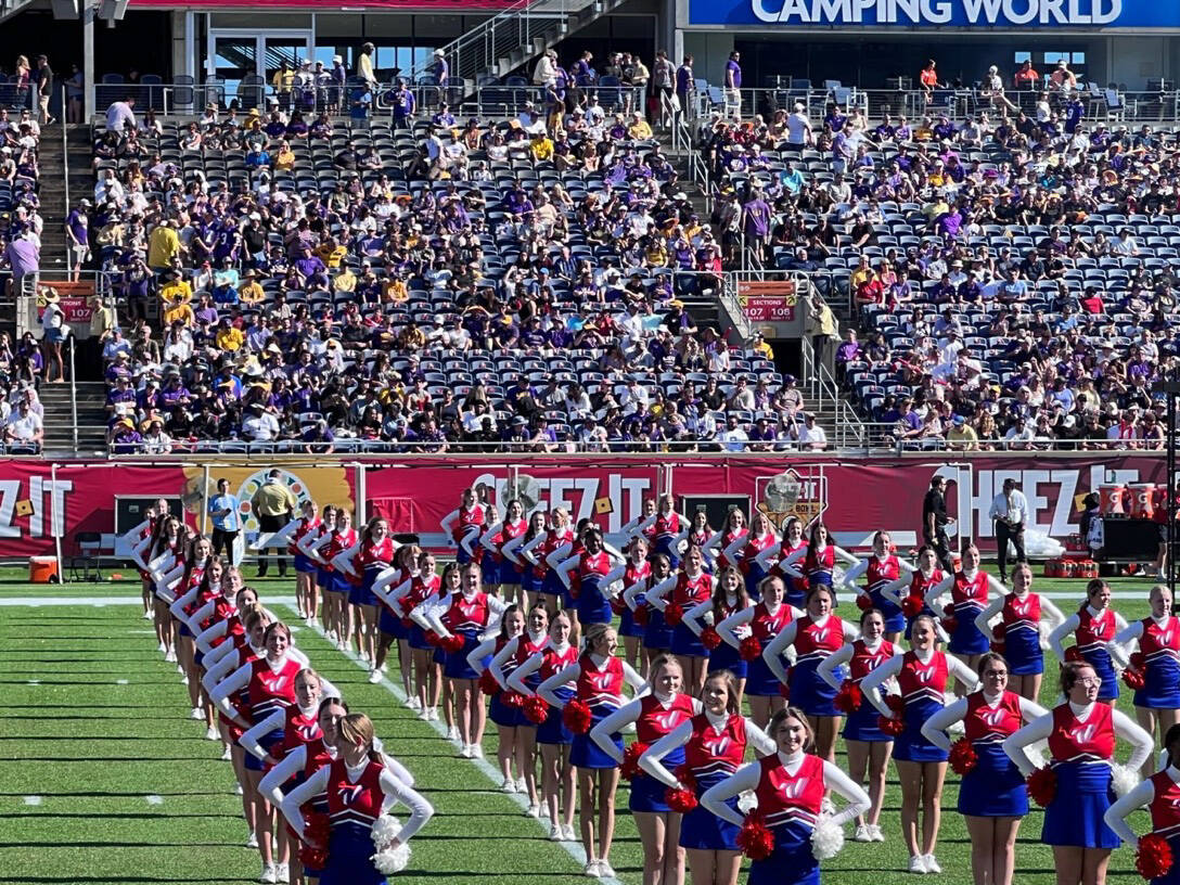 Cheerleaders, including members of the Kenai Central High School Cheerleading team, stand with hands on their hips during the pre-show performance at the Cheez-It Citrus Bowl on Monday, Jan. 1, 2023 at Camping World Stadium in Orlando, Florida. (Photo courtesy Sabrina McGraw)