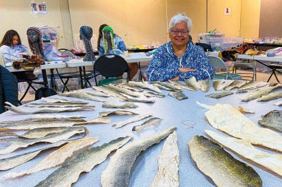 June Pardue with salmon skins during a workshop. (Photo provided)