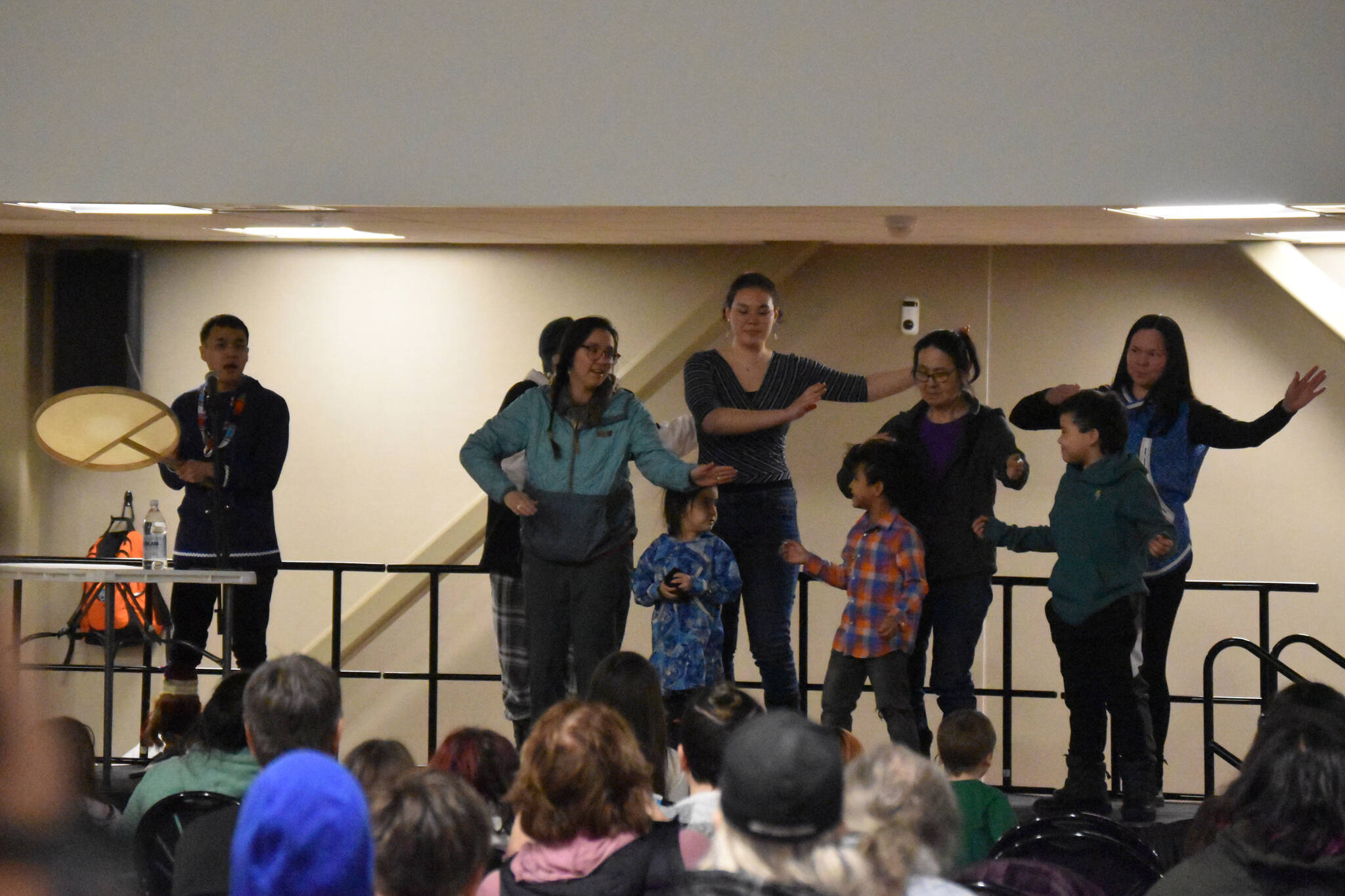 Byron Nicholai, of “I Sing, You Dance,” is joined on stage by members of the audience during a musical performance as part of the Kahtnuht’ana Hey Chi’ula NYO Invitational on Saturday, Jan. 14, 2023, at the Kahtnuht’ana Duhdeldiht Campus in Kenai, Alaska. (Jake Dye/Peninsula Clarion)