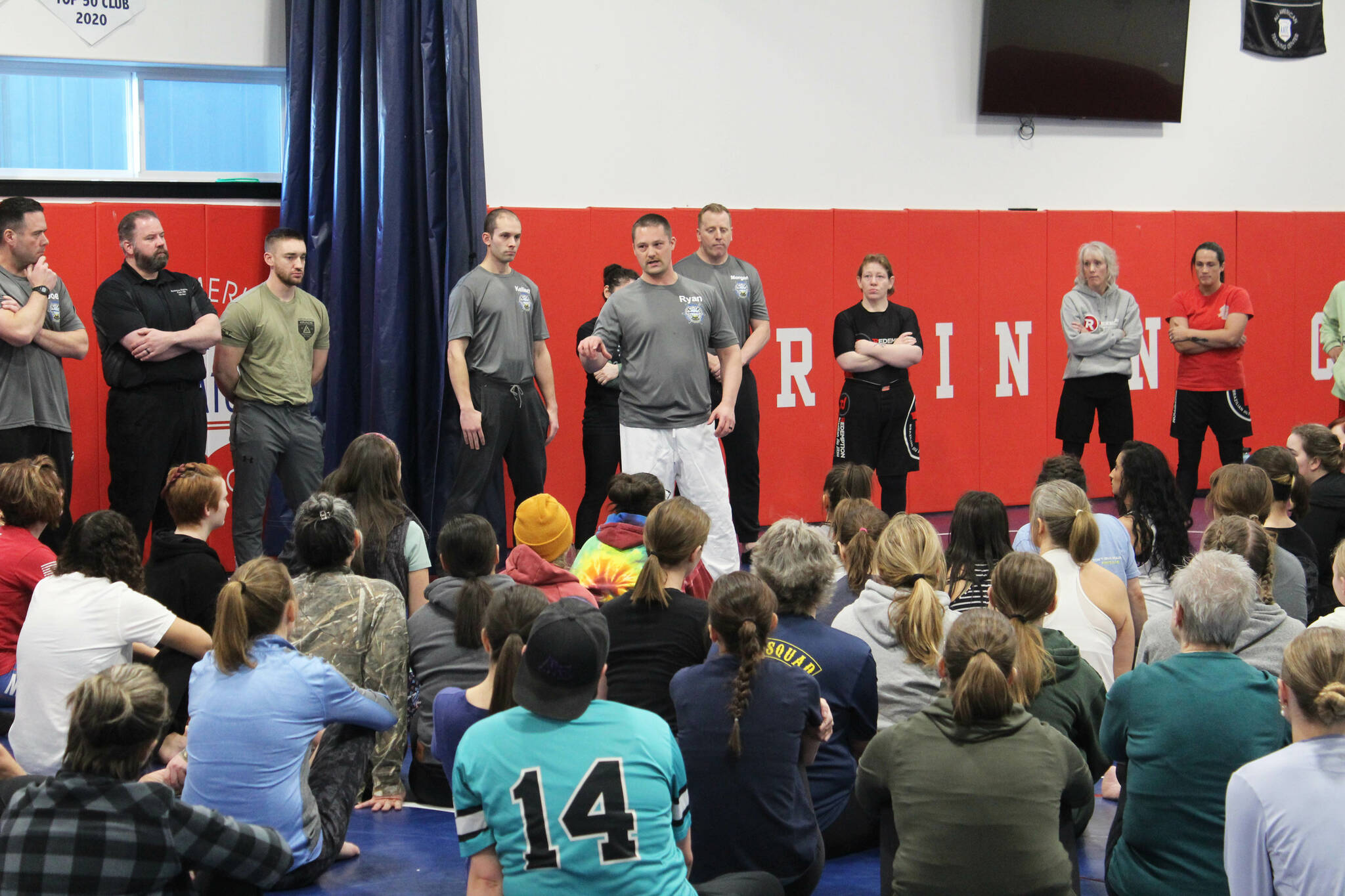 Homer Police Department Lt. Ryan Browning (center) provides opening remarks at a “Toss A Cop” event at the All American Training Center on Saturday, Jan. 21, 2023, in Soldotna, Alaska. (Ashlyn O’Hara/Peninsula Clarion)