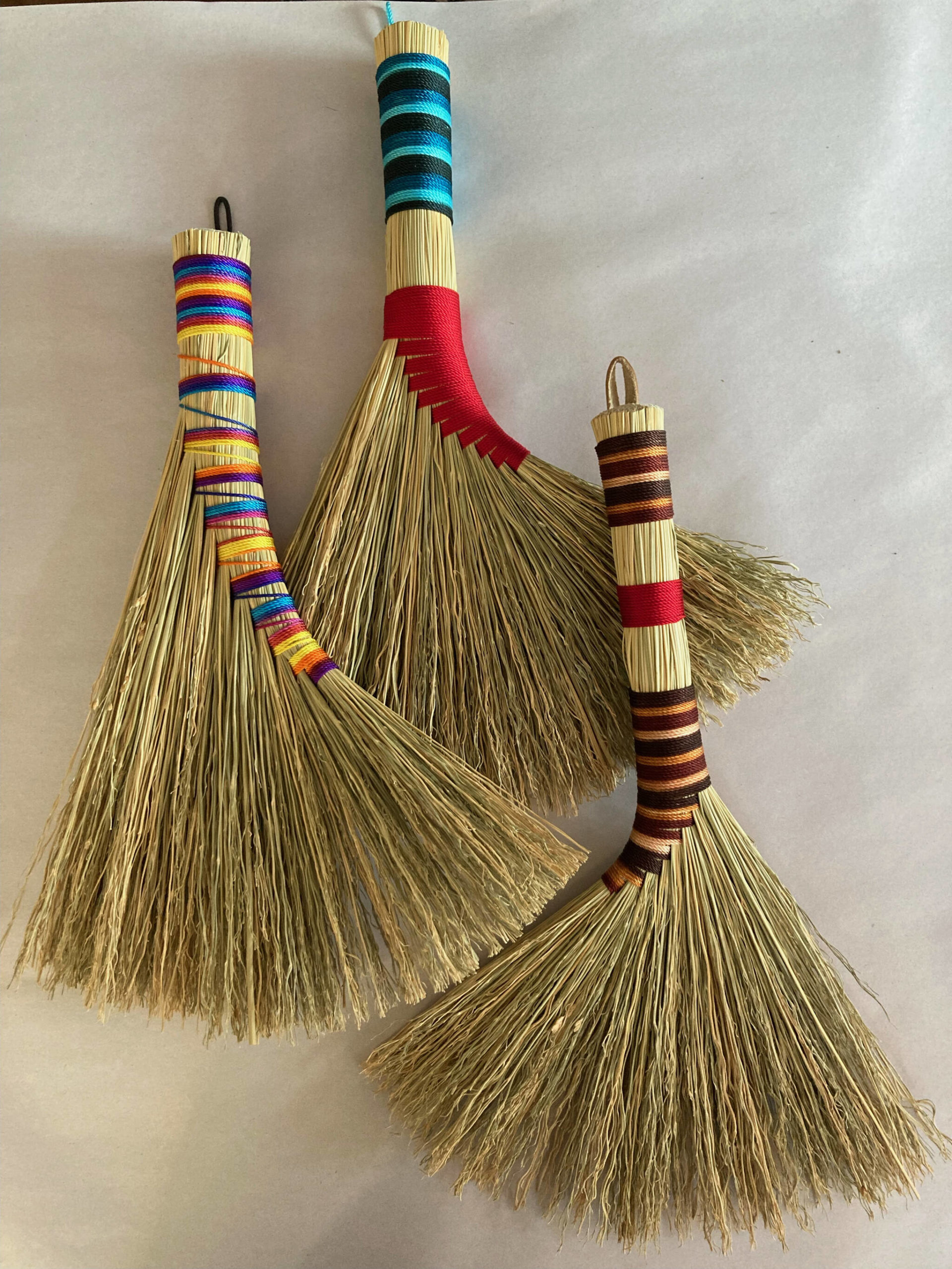 Handmade brooms by Willow Q Jones on display at Grace Ridge through February. (Photo by Willow Jones)