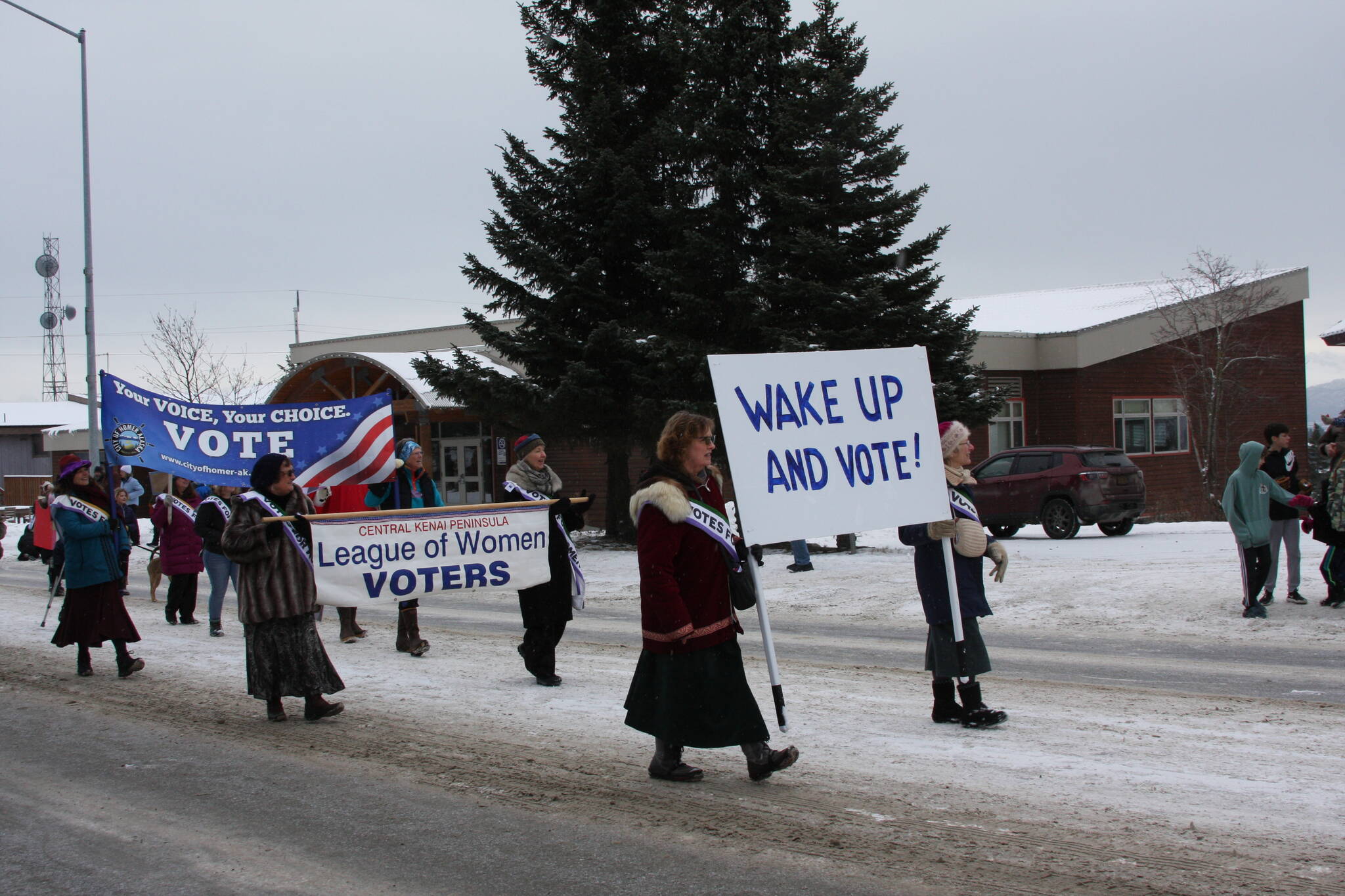 The Central Kenai Peninsula League of Women Voters march down Pioneer Avenue in the 69th annual Winter Carnival Parade on Saturday, Feb. 11, 2023 in Homer, Alaska. Photo by Delcenia Cosman