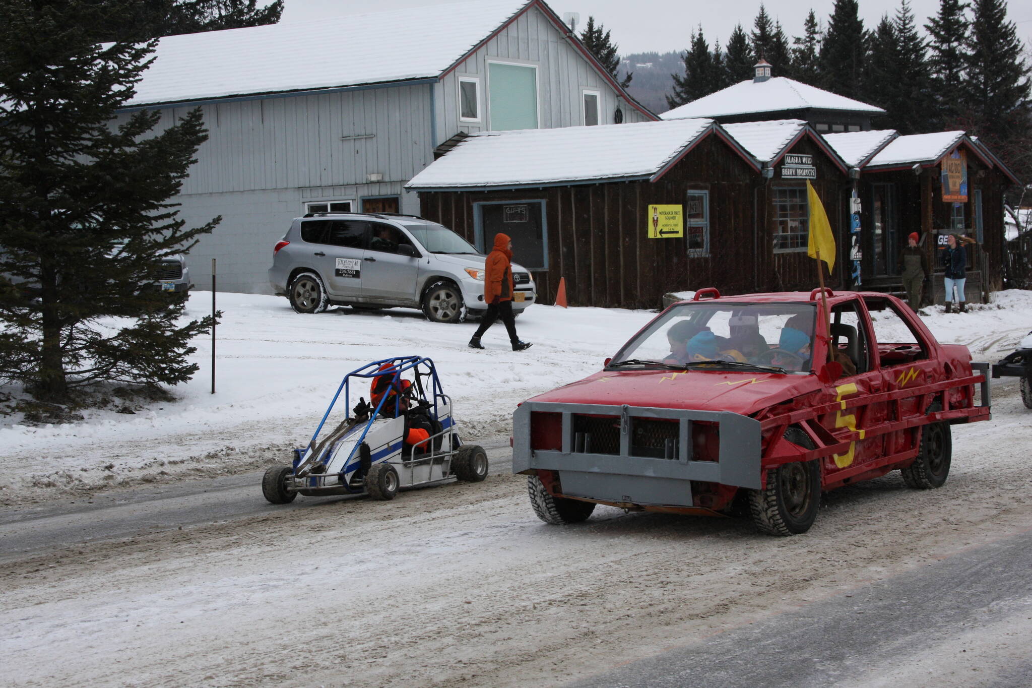 Drivers in the Homer Racing Association rumble down Pioneer Avenue in the 69th annual Winter Carnival Parade on Saturday, Feb. 11, 2023 in Homer, Alaska. Photo by Delcenia Cosman