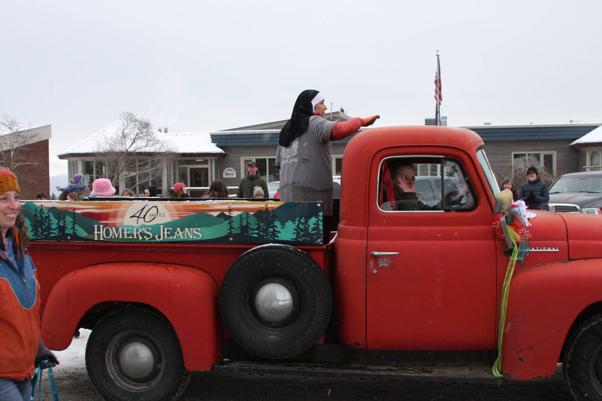 Homer’s Jeans employees, celebrating 40 years of business, drive down Pioneer Avenue in the 69th annual Winter Carnival Parade on Saturday, Feb. 11, 2023 in Homer, Alaska. Photo by Delcenia Cosman
