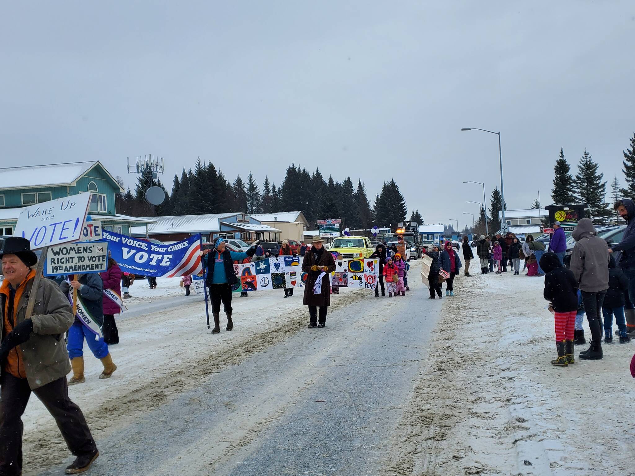 Photo by Delcenia Cosman
Homer residents watch parade participants walk down Pioneer Avenue in the 69th Annual Winter Carnival Parade on Saturday, Feb. 11, 2023 in Homer, Alaska.