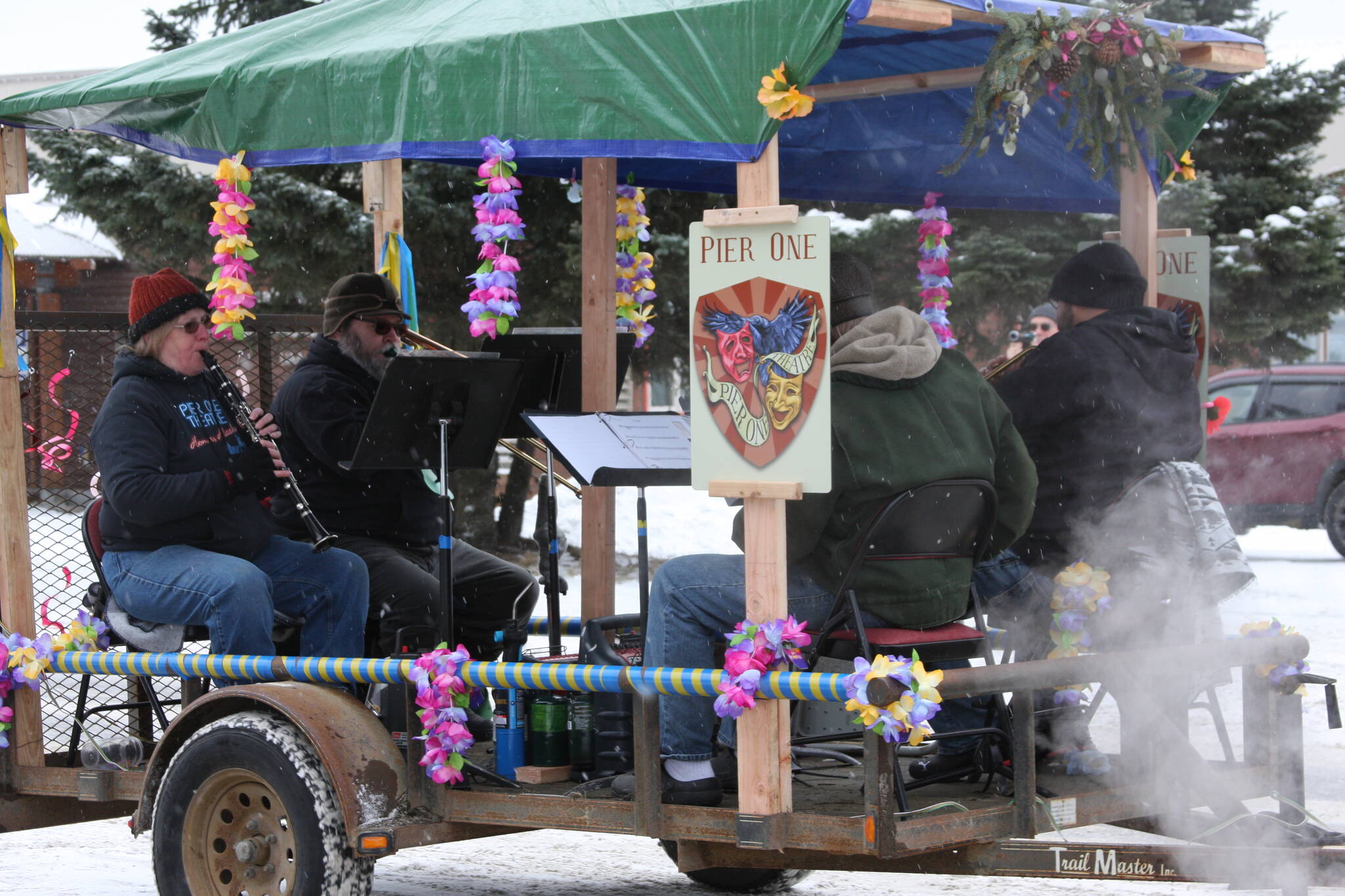 A quartet provides musical accompaniment on the Pier One Theatre float in the 69th Annual Winter Carnival Parade on Saturday, Feb. 11, 2023 in Homer, Alaska. Photo by Delcenia Cosman
