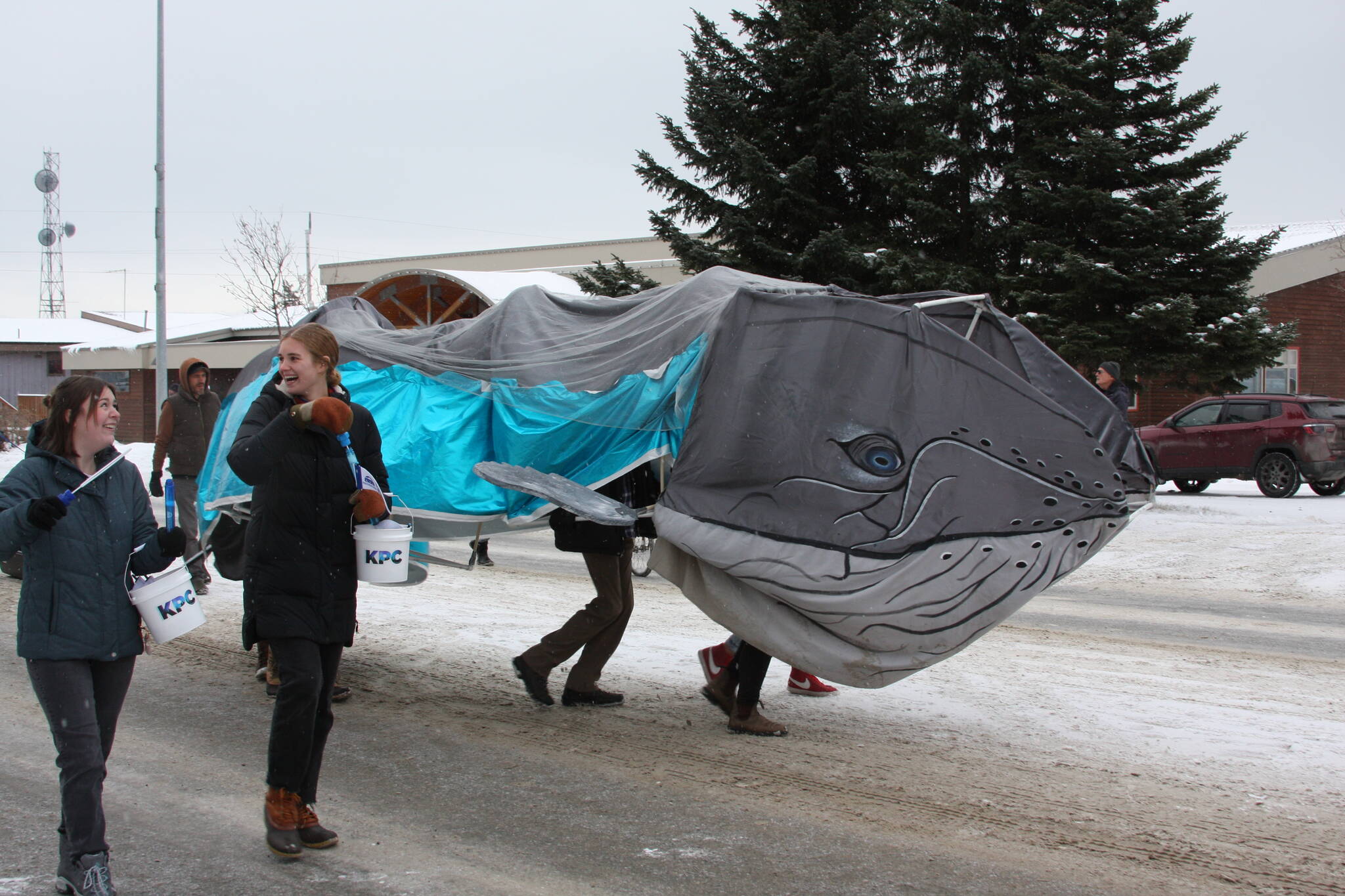 The Kachemak Bay Campus Student Association march with their mascot, “Harmony the Whale,” down Pioneer Avenue in the 69th Annual Winter Carnival Parade on Saturday, Feb. 11, 2023 in Homer, Alaska. Photo by Delcenia Cosman