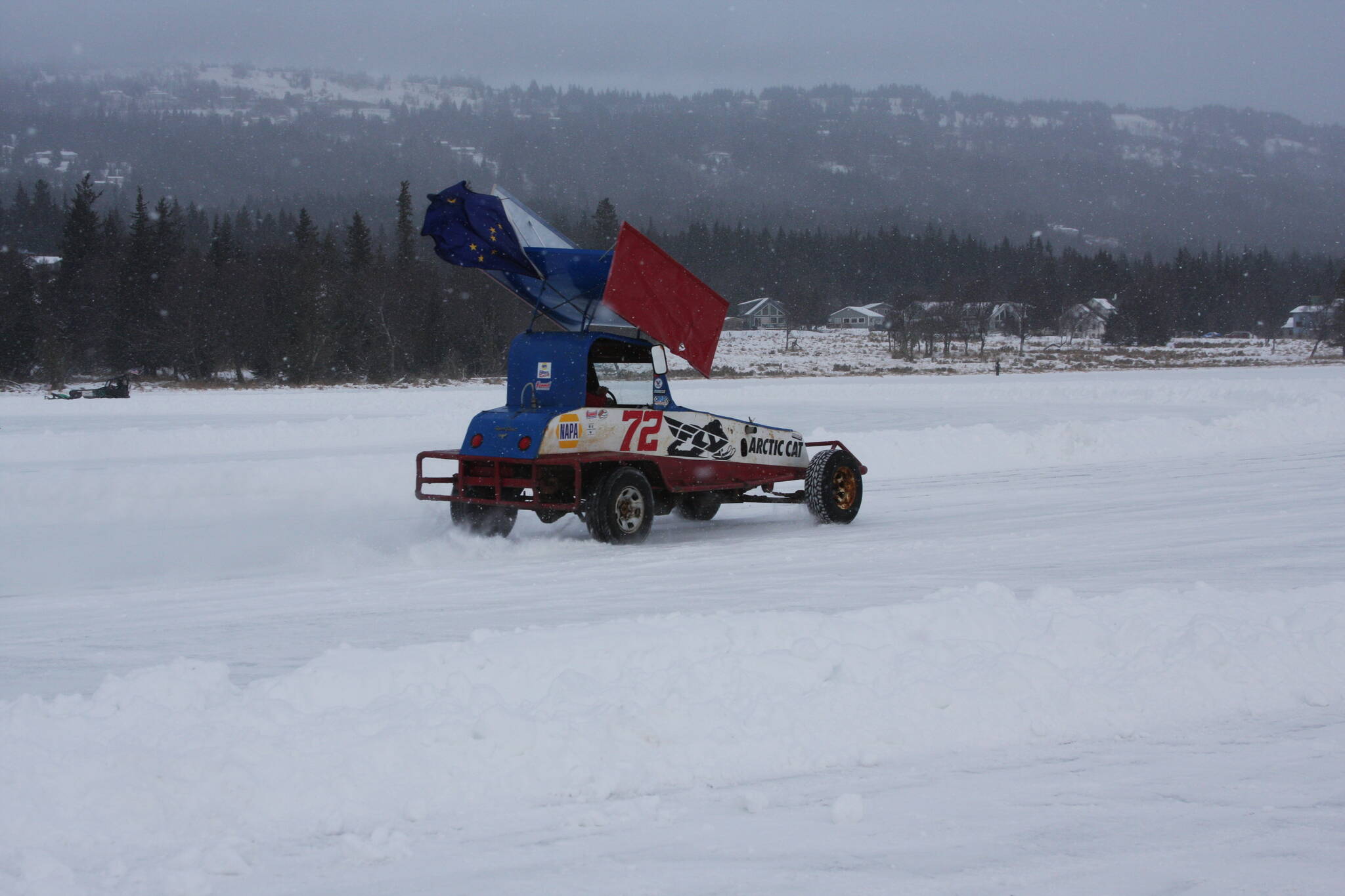 Photo by Delcenia Cosman/Homer News
A driver with the Homer Racing Association races around a plowed track on the frozen Beluga Lake on Saturday. Because of a lack of snow to create sufficiently sized safety berms on the ice track, the ice racing event scheduled after the Winter Carnival parade was scaled down. Racers sped around the track individually or racing in pairs.