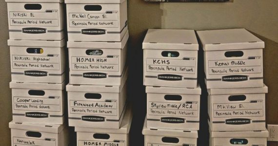 Boxes of period products are stacked, each destined for a specific school. (Photo courtesy Chera Wackler)