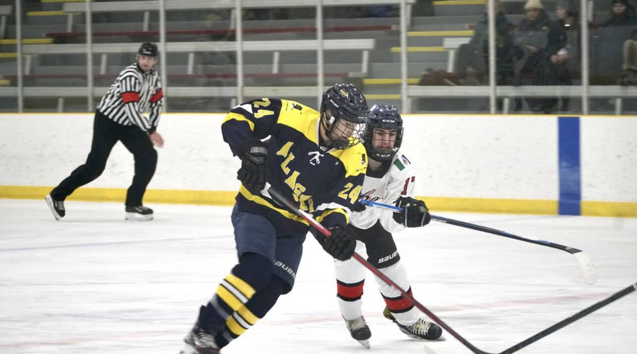 Matfey Reutov battles with another hockey player during the 2023 Arctic Winter Games in Wood Buffalo, Alberta. (Photo provided by Matfey Reutov)