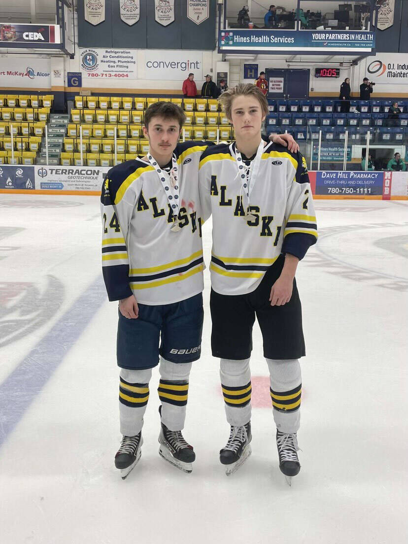Matfey Reutov and Brock Barth stand together on the ice, wearing their silver ulus. (Photo provided by Matfey Reutov)