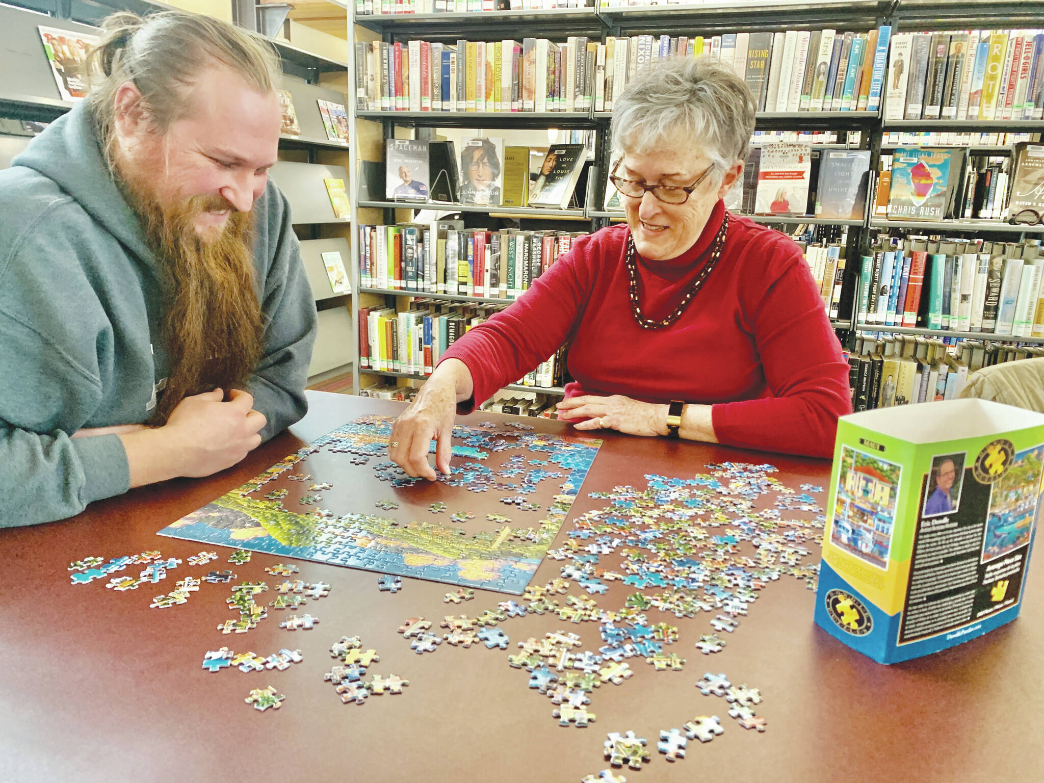Vasily Yakuni and Sue Oesting work on a puzzle at the Homer Public Library during Puzzlerama as part of the Homer Winter Carnival festivities on Feb. 11, 2023. (Photo by Christina Whiting/Homer News)
