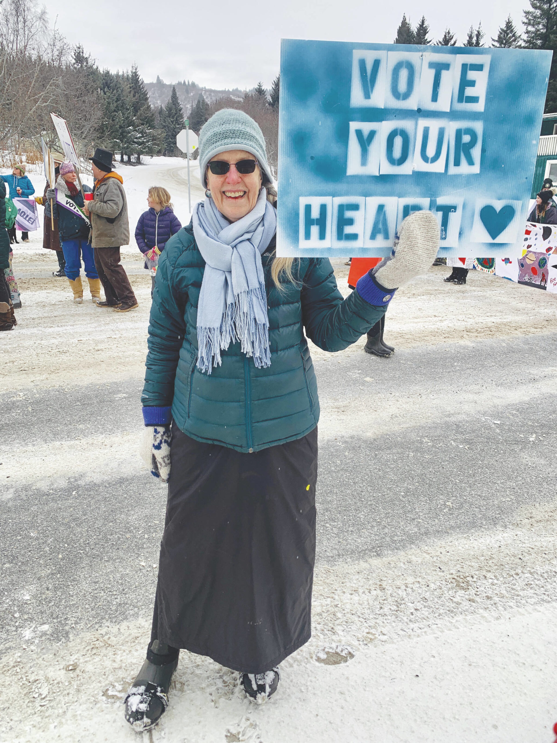 Nell Gustafson walks in the Homer Winter Carnival parade with the Central Kenai Peninsula League of Women Votes, Feb. 11. (Photo by Christina Whiting/Homer News)