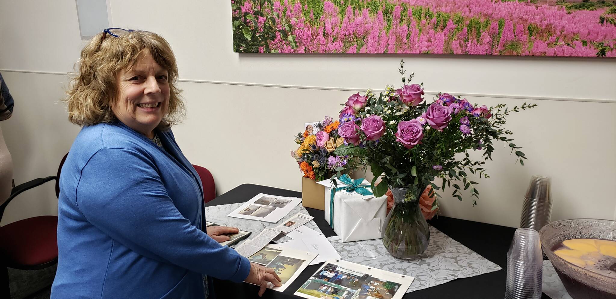 Colleen James looks through old photos of her 30 plus years of contributions to South Peninsula Hospital on Monday Feb. 20, 2023. Photo contributed by Derotha Ferraro.