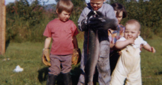 The Fenger children — (left to right) Heidi, Eric and Peter — delight in a bounty of silver salmon gathered by setnet below their home in August 1962. (Photo courtesy of the Fenger Family Collection)