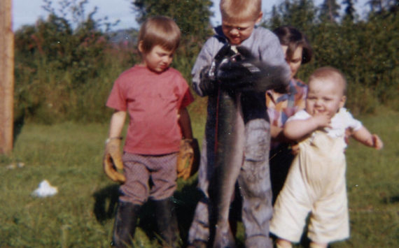 The Fenger children — (left to right) Heidi, Eric and Peter — delight in a bounty of silver salmon gathered by setnet below their home in August 1962. (Photo courtesy of the Fenger Family Collection)