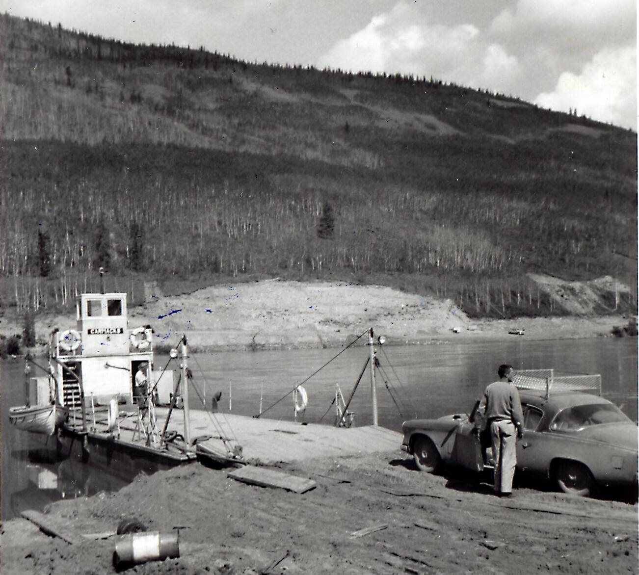 John Fenger took this photo when he traveled to Alaska in 1954 with Drs. Helen and Robert Whaley. Here, they are preparing to take their vehicles across the Stuart River in the Yukon Territory. Robert Whaley is standing by his car, while Helen Whaley is standing aboard the ferry. (Photo courtesy of the Fenger Family Collection)