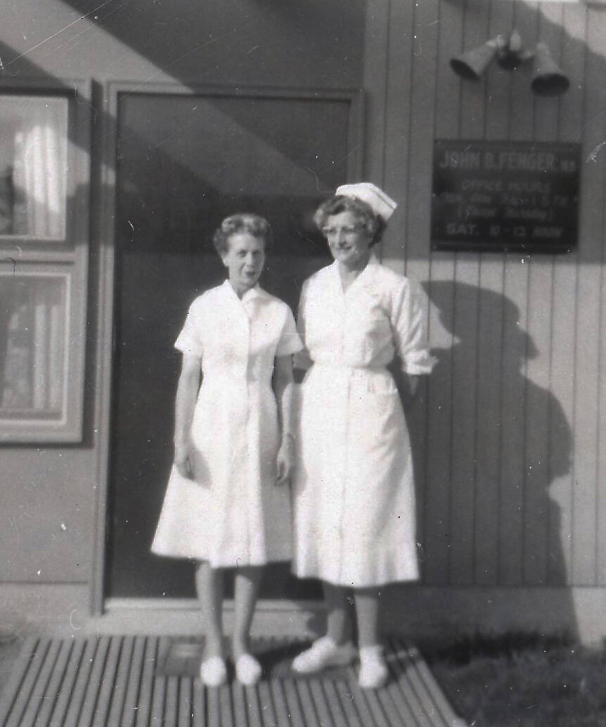 Registered nurses Kay Cowles (wife of Homer’s first mayor) and Wilma Cowgill pose in the sunshine outside of Dr. John Fenger’s clinic at the corner of Hohe and Cityview, east of the hospital in Homer. (Photo courtesy of the Fenger Family Collection)