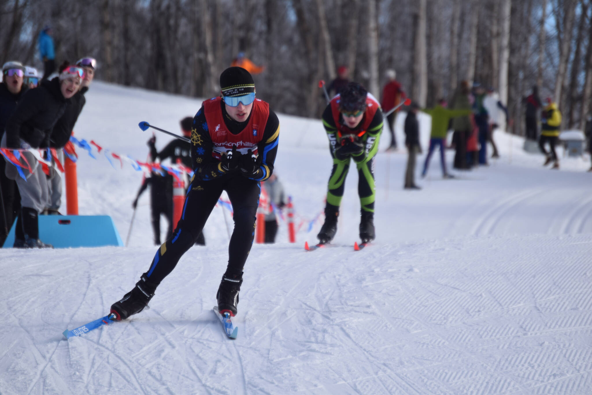 Photos by Jake Dye/Peninsula Clarion
Homer’s Garrett Briscoe tucks for a downhill, closely pursued by Colony’s Clayton Steer, during the first leg of the boys 4x5-kilometer relay at the ASAA State Nordic Ski Championships at Kincaid Park in Anchorage, Alaska, on Saturday, Feb. 25, 2023.