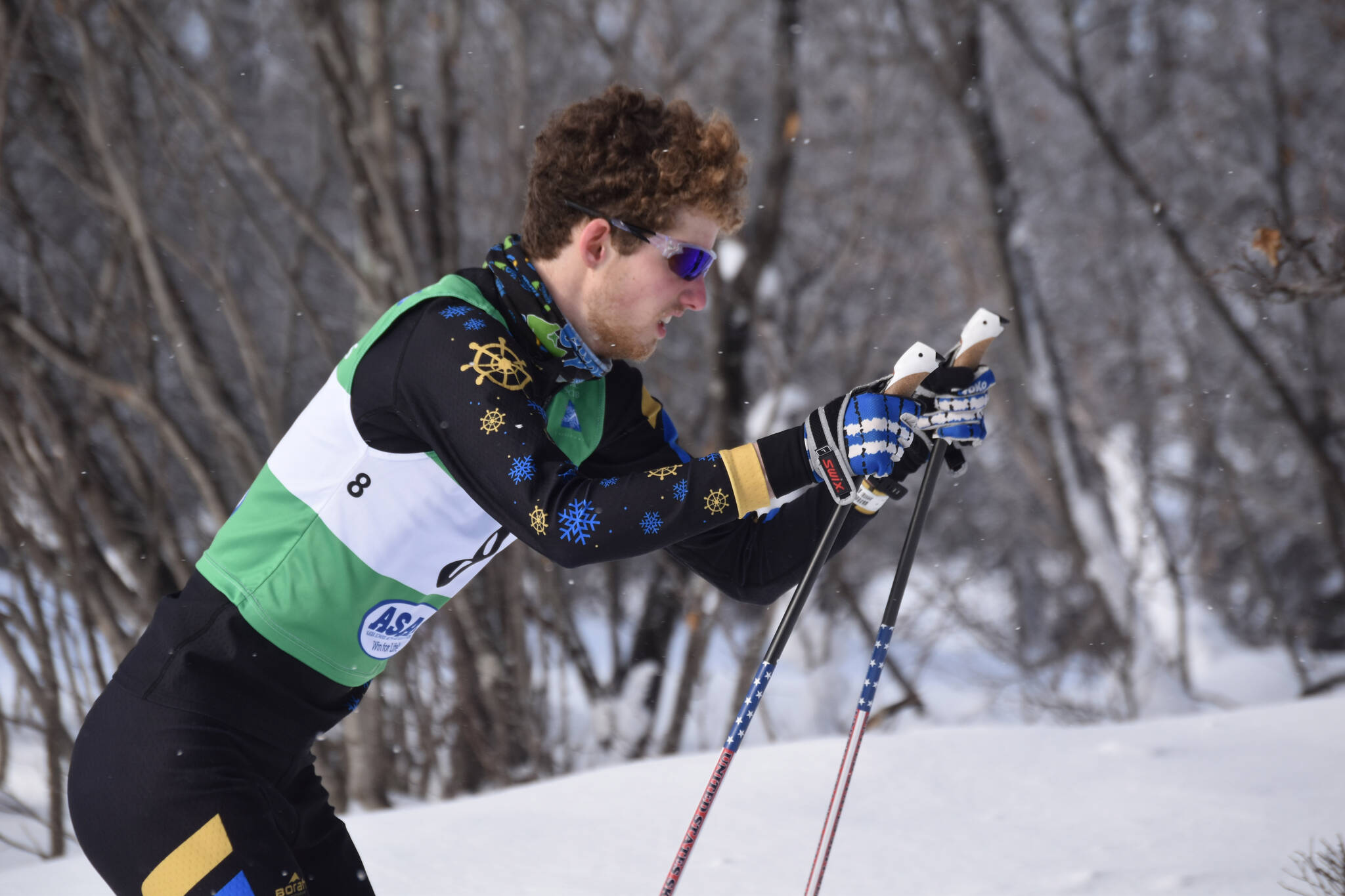 Homer’s Seamus McDonough puts his sticks in the snow as he charges uphill during the second leg of the boys 4x5-kilometer relay at the ASAA State Nordic Ski Championships at Kincaid Park in Anchorage, Alaska, on Saturday, Feb. 25, 2023. (Jake Dye/Peninsula Clarion)