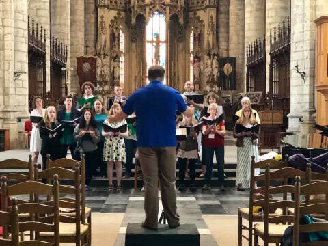 Photo by Shannon McBride-Morin/courtesy
Kyle Schneider directs choir at St. Michielskerk in Ghent, Belgium, summer 2019.